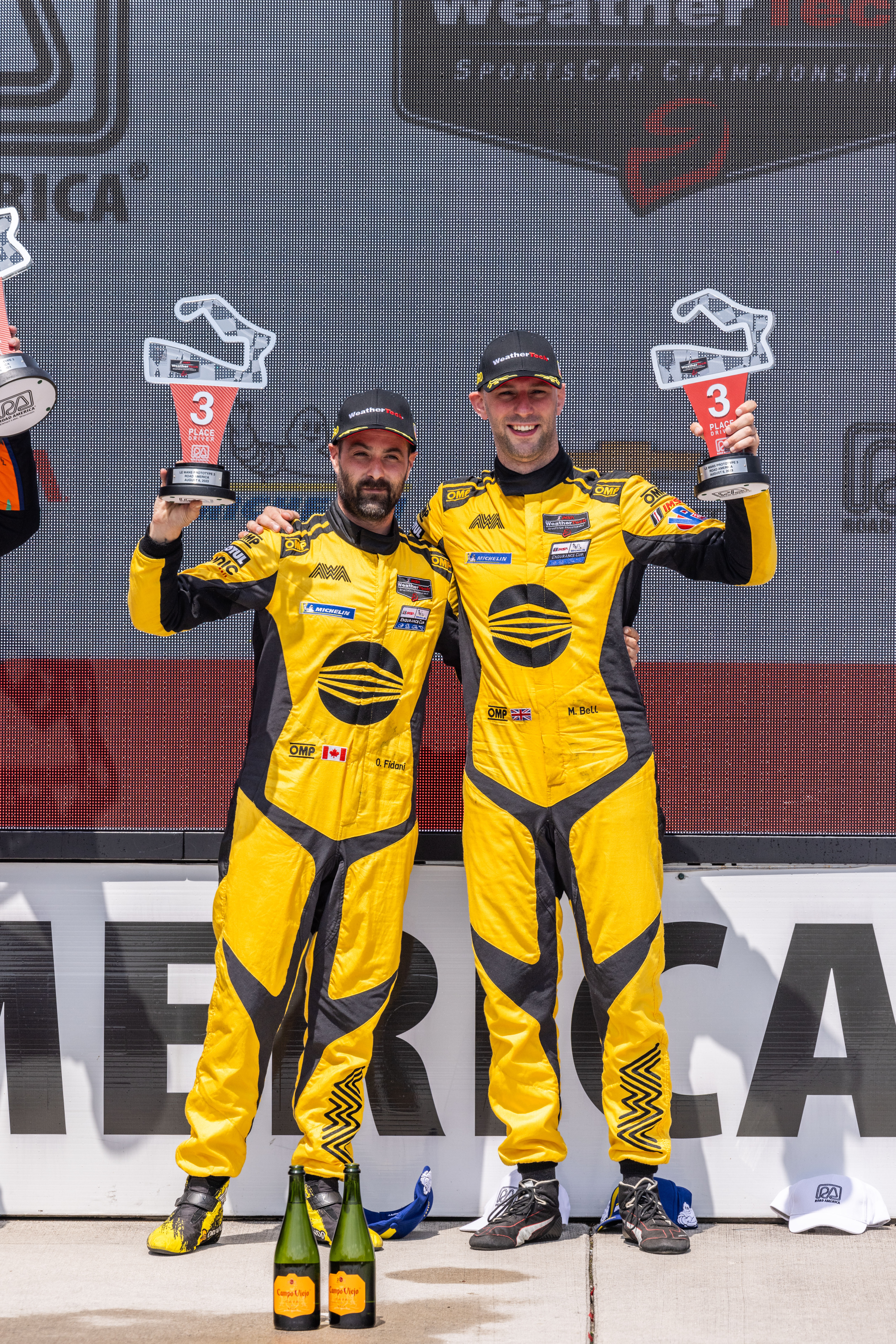 Matt Bell and team mate Orey on the podium with their trophies