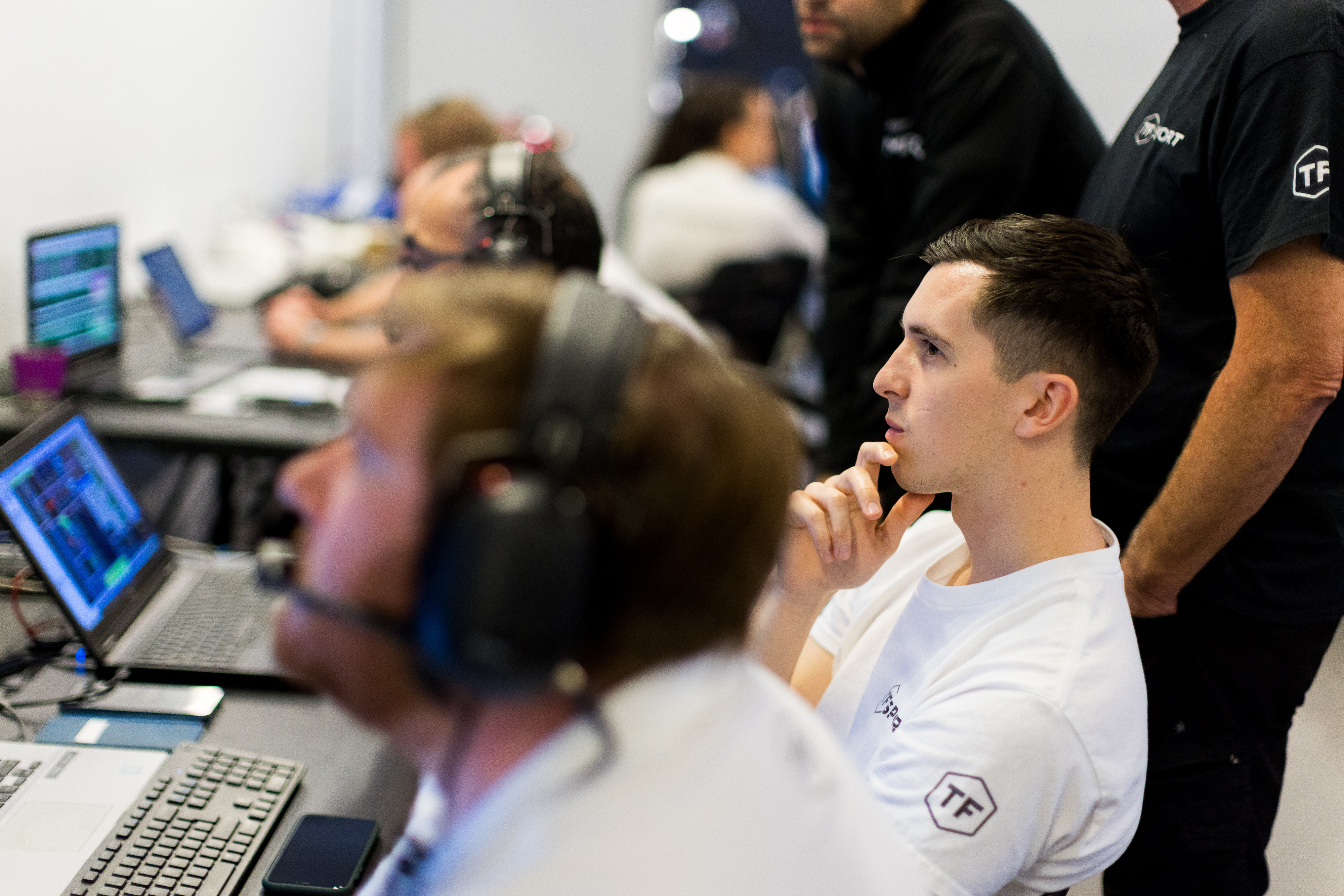 Ben Tuck in the back of the garage looking at data